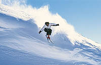 Aktivitäten im Winter - Skifahrer bei einer rasanten Abfahrt